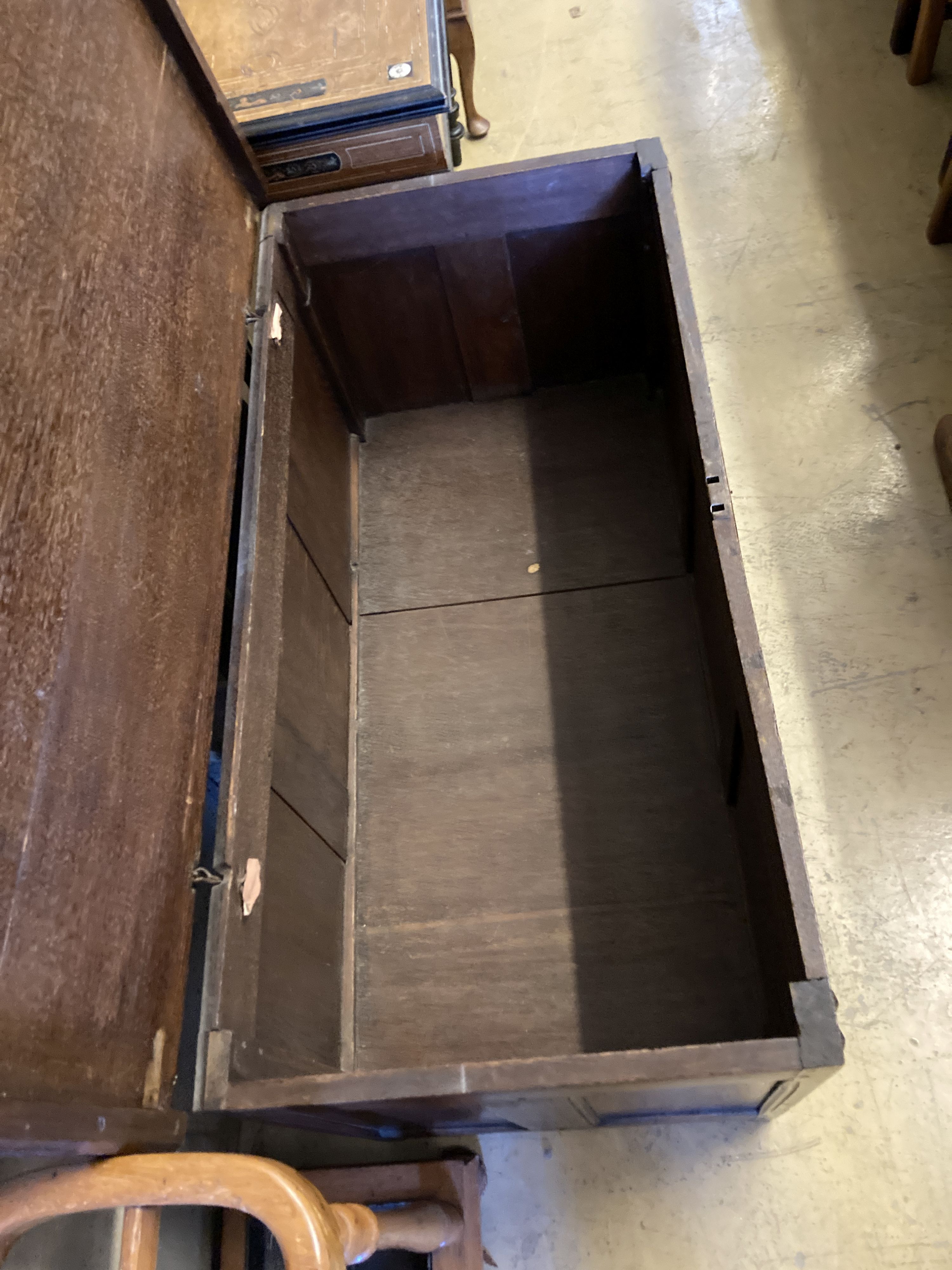 An 18th century panelled oak mule chest with planked top, length 118cm, depth 55cm, height 68cm